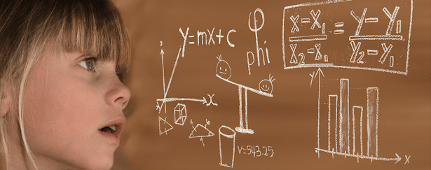 Child looking towards a brown chalkboard with fun Mathematics displayed in white text, handwritten with chalk