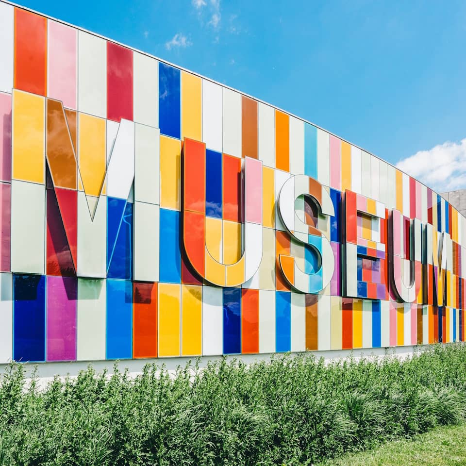 Wall of the Science Museum in many different colors with 'Museum' written in 3d letters on the wall